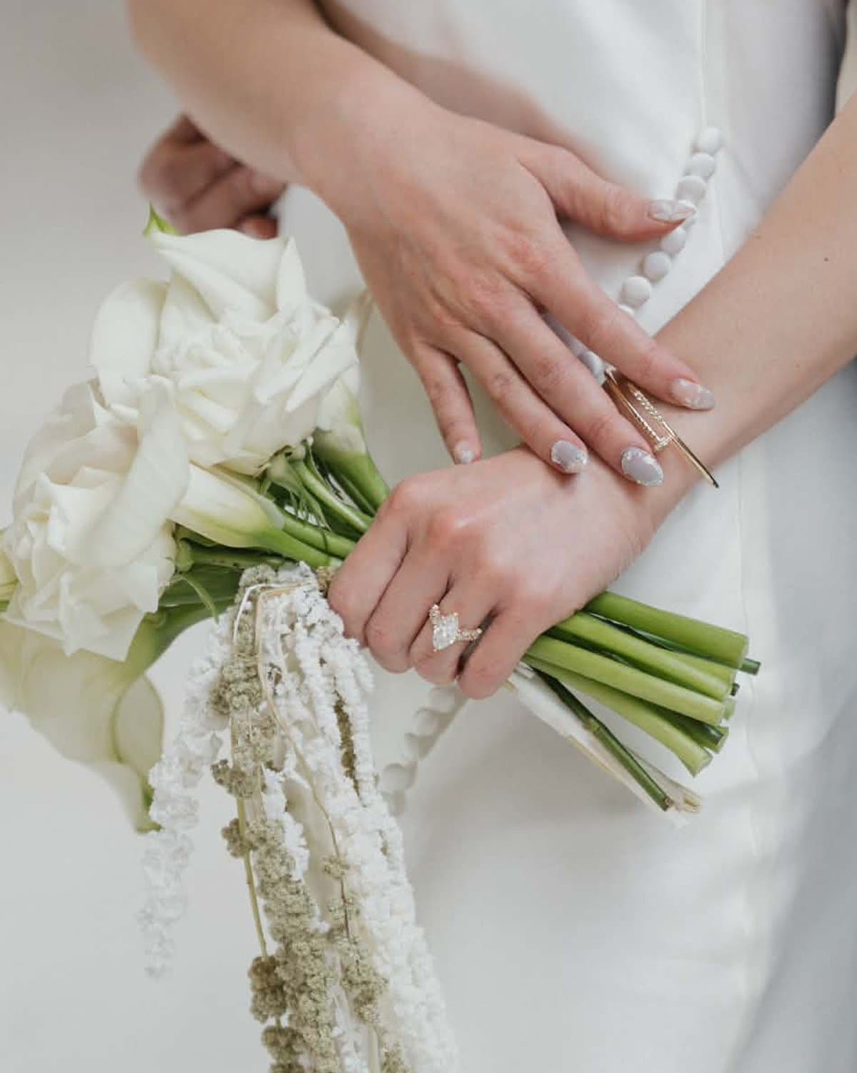 Bridal bouquet of white calla lilies and white roses with trailing white amaranthus