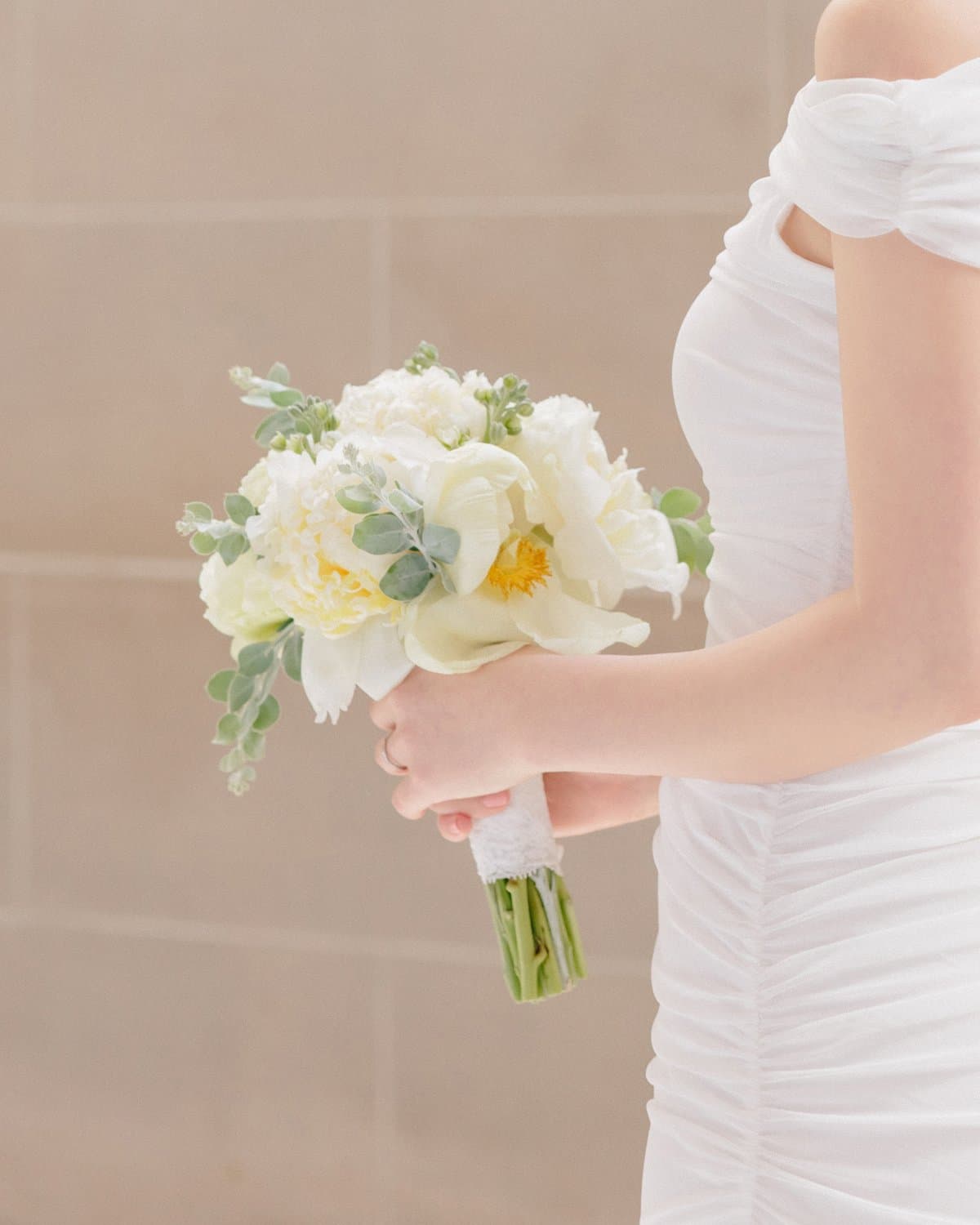 Petite white bridal bouquet of peonies and eucalyptus